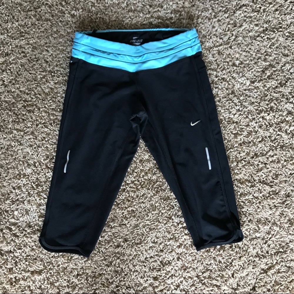 Nike running tights. Knee length, black and blue.